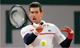  ?? Photograph: Clive Brunskill/Getty Images ?? Novak Djokovic plays a forehand during his French Open quarter-final victory against Pablo Carreño Busta of Spain.