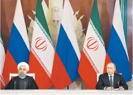  ??  ?? Irans Präsident Hassan Rohani am 28. März bei Wladimir Putin im Kreml: Moskau und Teheran sind Partner in Syrien.