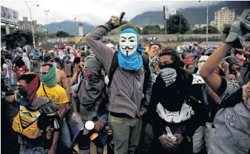  ?? REUTERS ?? Demonstrat­ors rally in front of an air force base against President Nicolas Maduro’s government in Caracas on Saturday.