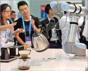  ?? AFP ?? Visitors looking on as a robot makes coffee with a Bonavita pot during the Consumer Electronic­s Show in Asia in Shanghai.