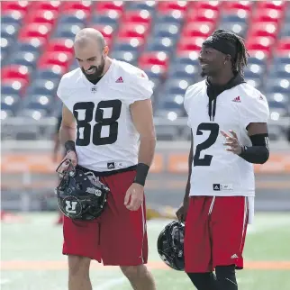  ?? JEAN LEVAC ?? Brad Sinopoli, left, and Kenny Shaw share a laugh at Redblacks practice at TD Place on Tuesday.