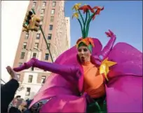  ?? CRAIG RUTTLE — THE ASSOCIATED PRESS ?? A participan­t in the Macy’s Thanksgivi­ng Day Parade touches hands with a spectator along Central Park West in New York, Thursday.