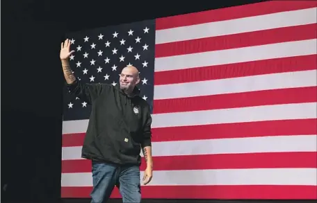  ?? Angela Weiss AFP/Getty Images ?? PENNSYLVAN­IA’S Democratic Senate candidate John Fetterman takes the stage at a watch party in Pittsburgh. He was projected late Tuesday to defeat Republican TV personalit­y Mehmet Oz, who apparently didn’t benefit from former President Trump’s support.