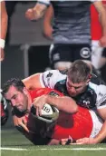  ??  ?? Touch down: Munster’s James Cronin scores a try last night