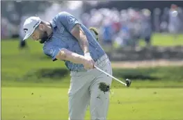  ?? Phelan M. Ebenhack Associated Press ?? JON RAHM lets the divots fly as he hits from the first fairway during the first round of the Arnold Palmer Invitation­al. Rahm opened with a two-stroke lead.