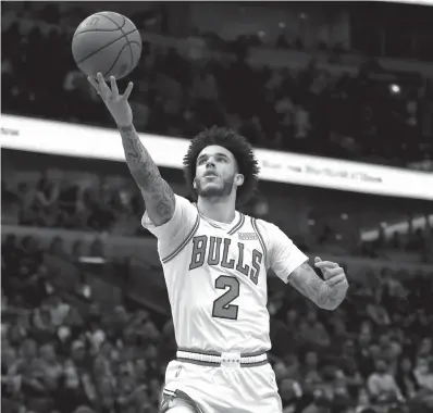  ?? CHRIS SWEDA/CHICAGO TRIBUNE ?? Lonzo Ball throws the ball off the backboard for an assist on a Zach LaVine dunk against the 76ers.