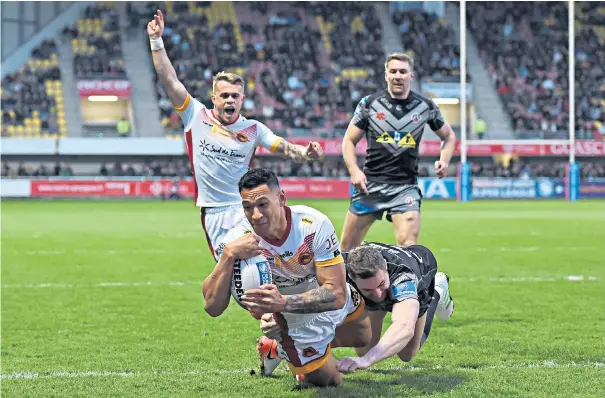  ??  ?? Making a splash: Israel Folau scores his first try in Super League on his debut for Catalans Dragons following his controvers­ial signing after he was sacked by Rugby Australia for posting homophobic comments on social media