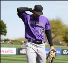  ?? ROSS D. FRANKLIN — THE ASSOCIATED PRESS ?? Injured Rockies outfielder Sean Bouchard walks back to the dugout during the first inning of a spring training game against the Angels on Wednesday in Tempe, Ariz.