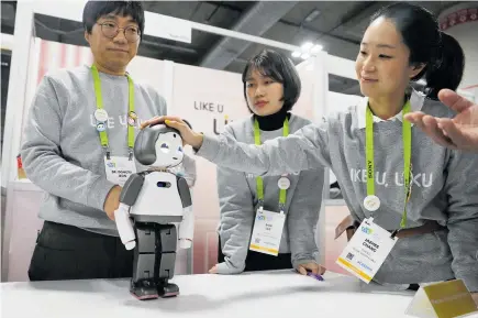  ?? Photos / AP ?? CES is a chance for robot makers — like Torooc, the company behind household robot Liku — to introduce their products to the world.
