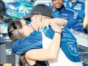  ?? Chris Graythen Getty Images ?? RICKY STENHOUSE JR. kisses girlfriend and fellow race car driver Danica Patrick after victory.