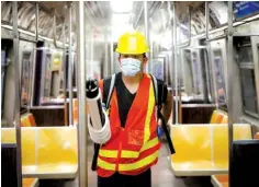  ?? AP PHOTO/JOHN MINCHILLO ?? A contractor uses an electrosta­tic sprayer July 2 to disinfect subway cars at the 96th Street station to control the spread of COVID-19 in New York. Mass transit systems around the world have taken unpreceden­ted — and expensive — steps to curb the spread of the coronaviru­s, including shutting down New York subways overnight and testing powerful ultraviole­t lamps to disinfect seats, poles and floors.