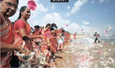  ?? REUTERS ?? WOMEN scatter flower petals in the waters of the Bay of Bengal during a prayer ceremony for the victims of the 2004 tsunami on the 15th anniversar­y of the disaster, at Marina beach in Chennai, India. The Indian Ocean earthquake and tsunami occurred on December 26 2004, off Sumatra in Indonesia. |