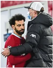  ?? — AP ?? Gladness and sadness: Manchester City coach Pep Guardiola celebratin­g with goal scorer Phil Foden (right) and Kyle Walker in the match against Borussia Dortmund in Germany. Liverpool boss Juergen Klopp consoling Mohamed Salah at the end of the match against Real Madrid at Anfield.