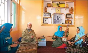  ??  ?? Sufi music teacher, Muhammad Yaqoob Sheikh (second left) teaches his students the nuances of Sufi music, on the outskirts of Srinagar. — AFP photos