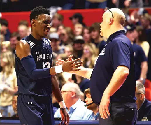  ?? ALLEN CUNNINGHAM/SUN-TIMES ?? DePaul Prep coach Tom Kleinschmi­dt (congratula­ting Jaylan McElroy) graduates just one player in the top seven from this year’s Class 2A champs.
