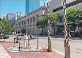  ?? PHILIP MARCELO/AP PHOTO ?? Light spires and one of the stone pillars stand along Boylston Street after installati­on was finished Monday in Boston to memorializ­e the Boston Marathon bombing victims.