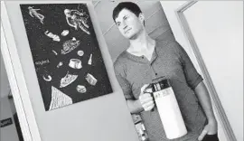  ?? Anne Cusack Los Angeles Times ?? ROB RHINEHART, the inventor of Soylent, holds a pitcher of the meal-in-abottle drink at the company’s office in downtown Los Angeles in 2015.