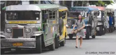  ?? ED GUMBAN_PHILIPPINE STAR ?? A COMMUTER walks past a row of parked jeepneys in this September file photo.