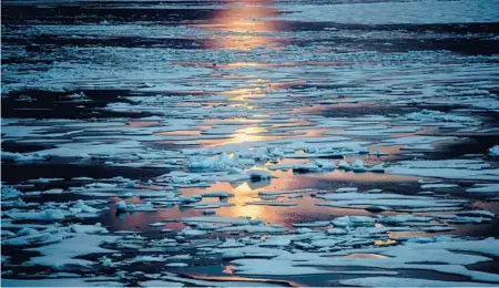  ?? DAVID GOLDMAN/AP 2017 ?? The midnight sun shines across sea ice along the Northwest Passage in the Canadian Arctic Archipelag­o.