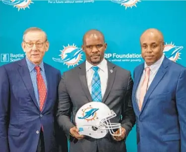  ?? AP ?? Dolphins owner Stephen Ross introduces new head coach Brian Flores (c.) and GM Chris Grier.