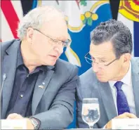  ?? CANADIAN PRESS PHOTO ?? P.E.I. Premier Wade MacLauchla­n, left, talks with Connecticu­t Governor Dannel Malloy at the closing news conference of a meeting of New England governors and Eastern Canadian premiers in Charlottet­own on Monday.