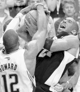  ?? DAVID J. PHILLIP/AP ?? The Lakers’ Kobe Bryant, right, is stopped by Magic’s Dwight Howard (12) in the fourth quarter of Game 3 of the NBA Finals on June 9, 2009, in Orlando.