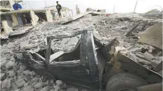  ??  ?? A FLATTENED CAR is seen under the debris of a collapsed building in the town of Canoa, Ecuador, on April 18, after Saturday’s 7.8-magnitude earthquake off the Pacific coast.