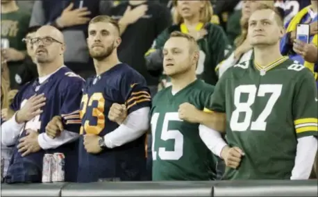  ?? ASSOCIATED PRESS ?? Fans lock arms during Chicago Bears. the national anthem before the Thursday night NFL game between the Green Bay Packers and the
