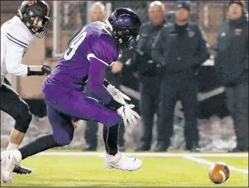  ?? SUZANNE TENNANT/POST-TRIBUNE ?? Merrillvil­le’s Nick Price, right, scrambles for a fumble during the Class 6A regional against Warsaw.