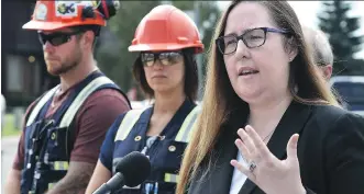 ?? ED KAISER ?? Alberta Minister of Labour Christina Gray, right, talks at a news conference about the steps being taken to improve safety inspection­s for residentia­l constructi­on worksites.