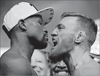  ?? [JOHN LOCHER/THE ASSOCIATED PRESS] ?? Floyd Mayweather Jr., left, and Conor McGregor face off during a weigh-in Friday in Las Vegas.