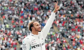  ??  ?? Lewis Hamilton celebrates claiming title number five at Sunday’s Mexico Grand Prix.