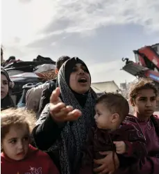  ?? Getty Images; Bloomberg ?? Above, Palestinia­n women are left to cope with the worst the war throws at them; right, mourning the dead at the Nasser Medical Hospital in Khan Younis