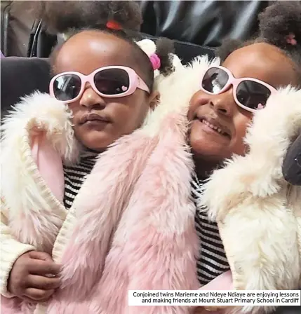  ??  ?? Conjoined twins Marieme and Ndeye Ndiaye are enjoying lessons and making friends at Mount Stuart Primary School in Cardiff