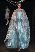  ??  ?? Liquidised organza transforme­d into a diaphanous cape at Iris van Herpen Haute Couture Autumn/Winter ’18