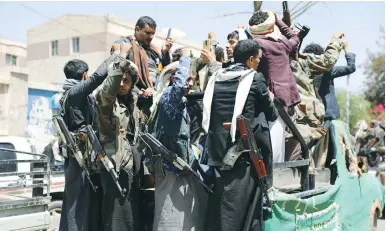  ?? (Khaled Abdullah/Reuters) ?? ARMED HOUTHI FOLLOWERS ride on the back of a truck outside a hospital in Sanaa on Wednesday.