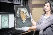  ?? NEIL HANNA AP ?? Senior Conservato­r Lesley Stevenson holds Vincent Van Gogh’s ‘Head of a Peasant Woman’ alongside an X-ray image of a previously unknown Van Gogh self-portrait. Stevenson discovered the self-portrait behind ‘Peasant Woman’ while she was preparing it for an exhibition.