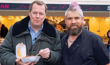  ?? ?? Tucking in: Tom Parker Bowles with Ben Newman. Top, long queues for his spud truck