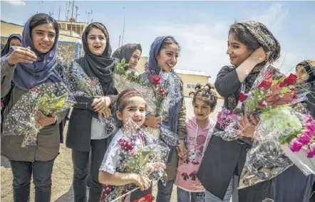  ??  ?? Somaya Faruqi, from left, Kowsar Roshan, Fatemah Qaderyan, and Sahar Barak were welcomed home to TV cameras, bouquets of plastic roses, and families relieved to have their daughters safely home.