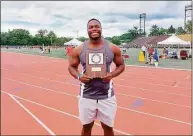  ?? Dan Nowak / Hearst Connecticu­t Media ?? Gary Moore Jr. of Hillhouse holds the first-place plaque for winning the discus at the New England track meet.