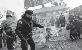  ??  ?? Protesters burn a portrait of Kim Yong Chol, vice chairman of North Korea's ruling Workers' Party Central Committee, during a rally against a planned visit by a North Korean delegation in Seoul, South Korea, Saturday. AP