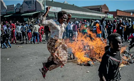  ?? AP ?? Opposition MDC party supporters protest in the streets of Harare during clashes with police.