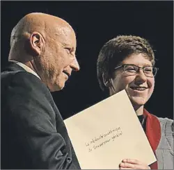  ??  ?? Paul Cyr of the Department of Education, Early Learning and Culture presents the Governor General’s Award to École François Buote student Sarah Buote during the school’s graduation ceremony June 22.