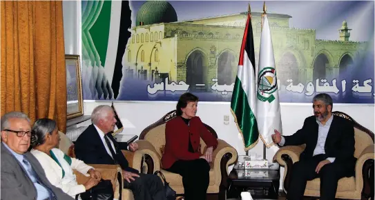  ?? (Reuters) ?? FORMER US President Jimmy Carter (third left) meets Hamas leader Khaled Mashaal (right) in Damascus alongside other members of a delegation of ‘The Elders,’ including Henry Kissinger (left), in 2010.