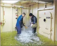  ?? JONATHAN RILEY/TC MEDIA ?? Canadian astronaut Jeremy Hansen holds a wedge in place for Truro Daily News reporter Jonathan Riley as they work together in a flooding simulator at the Kootenay Damage Control Training Facility near Halifax.