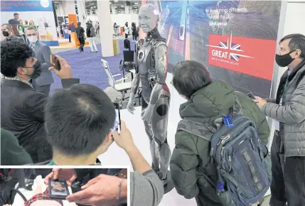  ?? GETTY IMAGES/ AFP ?? LEFT
Attendees look at a humanoid named Ameca at CES 2022 in Las Vegas on Wednesday.