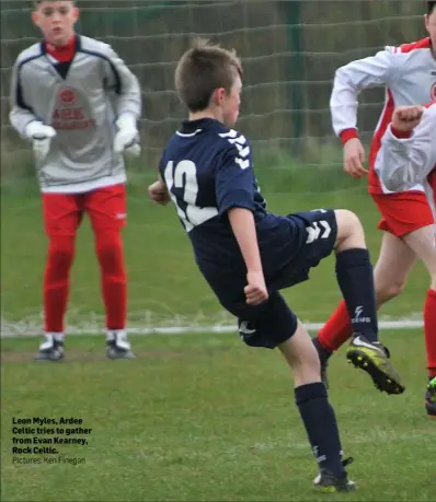  ?? Pictures: Ken Finegan ?? Leon Myles, Ardee Celtic tries to gather from Evan Kearney, Rock Celtic.