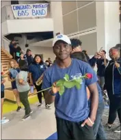  ?? ?? Chimaobi Iwuanyanwu, the alto saxophone section leader for the 605 All Star Band, holds a rose after learning that the super band will march in the 2025 Rose Parade.
