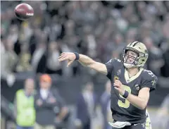  ?? AFP ?? Saints quarterbac­k Drew Brees throws a touchdown pass against the Eagles.