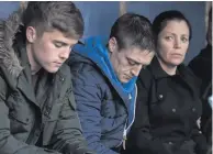  ??  ?? Solace: Louise James at a candleligh­t vigil in Inishowen with her brothers, Derry City player Joshua and Johnny James